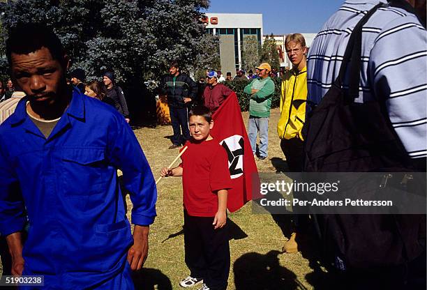 Young boy holds an AWB flag , a right wing movement, on June 12, 2004 in central Potchefstrom, South Africa. Eugene Terre Blanche, the leader of the...