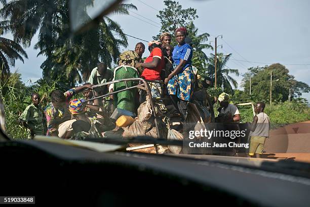 Women and children ride in the back of a "bush taxi" on October 12, 2013 in Kattin, Central African Republic. These bush taxis, along with pick-up...