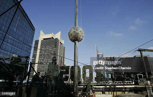 The New Year's Eve ball makes its way up the 77-foot-tall pole during its annual test run atop 1 Times Square December 30, 2004 in New York City. The...