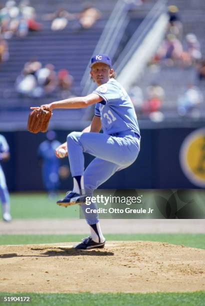 Bret Saberhagen of the Kansas City Royals winds up for a pitch during a game against the Oakland Athletics at Oakland-Alameda County Coliseum in 1986...