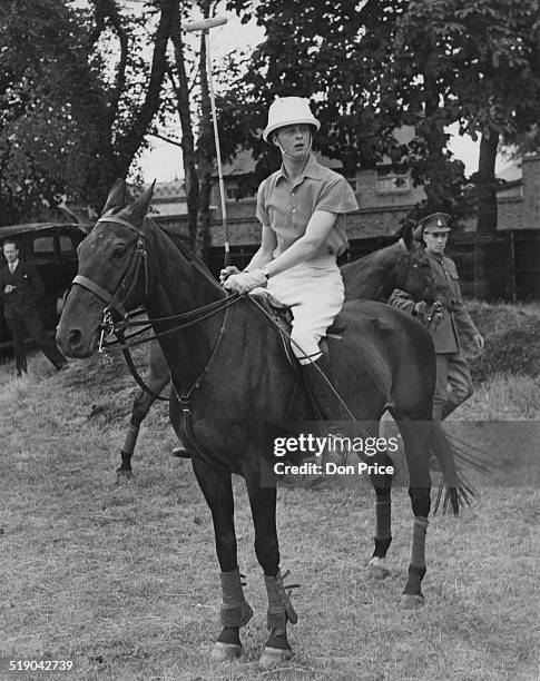 John Spencer-Churchill, Marquess of Blandford ready to play for the Cowdray Park team against Beechwood at a polo tournament at Roehampton, London,...