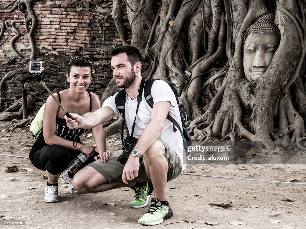 Tourists couple doing a selfie at a landmark in Ayutthaya