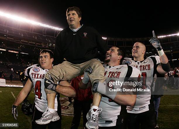 Head Coach Mike Leach of the Texas Tech Red Raiders gets carried off the field after his team's 45-31 win over the California Golden Bears during the...