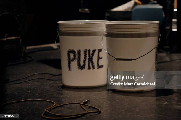 Buckets labled "Piss" and "Puke" sit on stage as Guided by Voices perform the final shows of their career on December 30, 2004 at the Metro in...