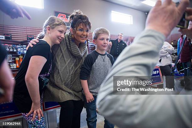 Former Alaska Gov. Sarah Palin greets people as she campaigns for republican presidential candidate Donald Trump at Zingers & Flingers indoor...