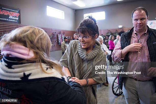 Former Alaska Gov. Sarah Palin greets people as she campaigns for republican presidential candidate Donald Trump at Zingers & Flingers indoor...