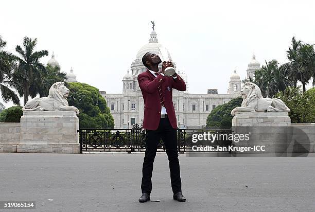 Darren Sammy, Captain of the West Indies poses with the trophy during a photocall after winning the Final of the ICC Men's World Twenty20 at the...