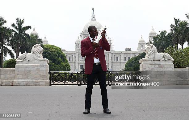 Darren Sammy, Captain of the West Indies poses with the trophy during a photocall after winning the Final of the ICC Men's World Twenty20 at the...