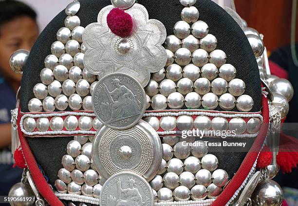 Close up of an Akha womens headdress made from hand forged silver, coins, handwoven cotton, market bought cotton, plastic beads, bamboo, cowrie...