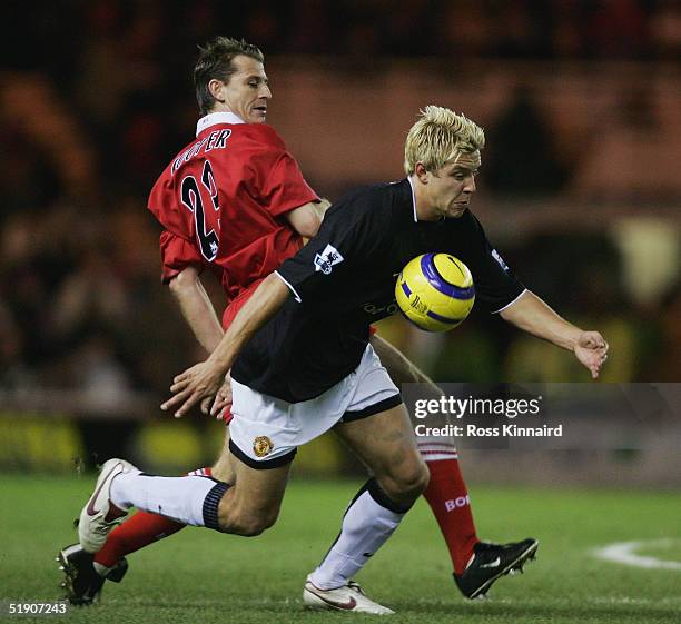 Alan Smith of Manchester is challenged by Colin Cooper of Middlesbrough during the Barclays Premiership match between Middlesbrough and Manchester...