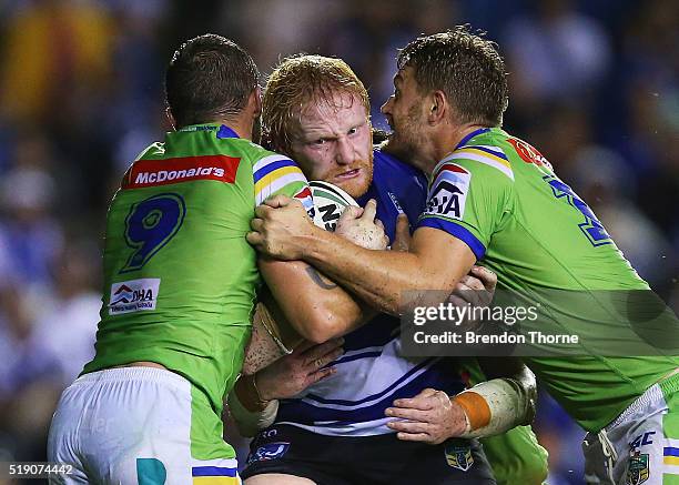 James Graham of the Bulldogs is tackled by the Raiders defence during the round five NRL match between the Canterbury Bulldogs and the Canberra...
