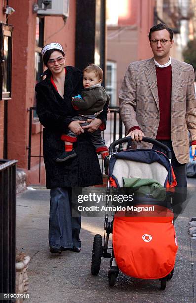 Model/Actress Karen Duffy walks in SoHo with husband John Lambros and son John Augustine January 1, 2004 in New York City.