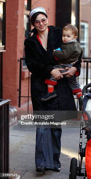 Model/Actress Karen Duffy walks in SoHo with husband John Lambros and son John Augustine January 1, 2004 in New York City.