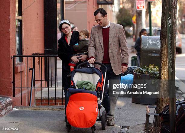 Model/Actress Karen Duffy walks in SoHo with husband John Lambros and son John Augustine January 1, 2004 in New York City.