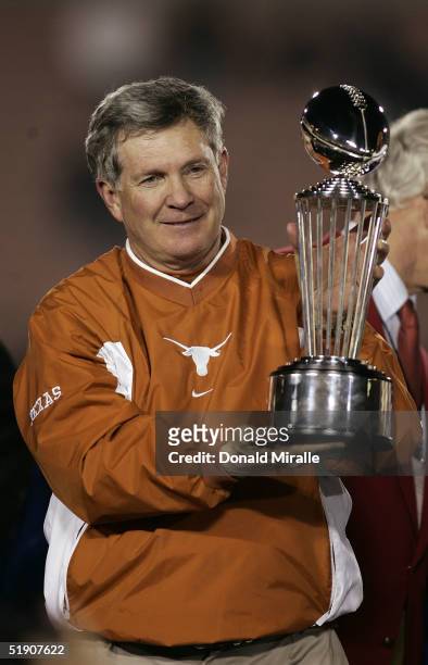 Head coach Mack Brown of the Texas Longhorns celebrates victory with the trophy after winning the Rose Bowl over the Michigan Wolverines in the 91st...