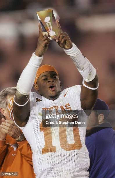 Quarterback Vince Young of the Texas Longhorns celebrates with the MVP trophy after a victory over the Michigan Wolverines in the 91st Rose Bowl Game...