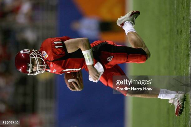 Quarterback Alex Smith of Utah runs with the ball in the first quarter against Pittsburgh in the Tostito's Fiesta Bowl at the Sun Devil Stadium on...