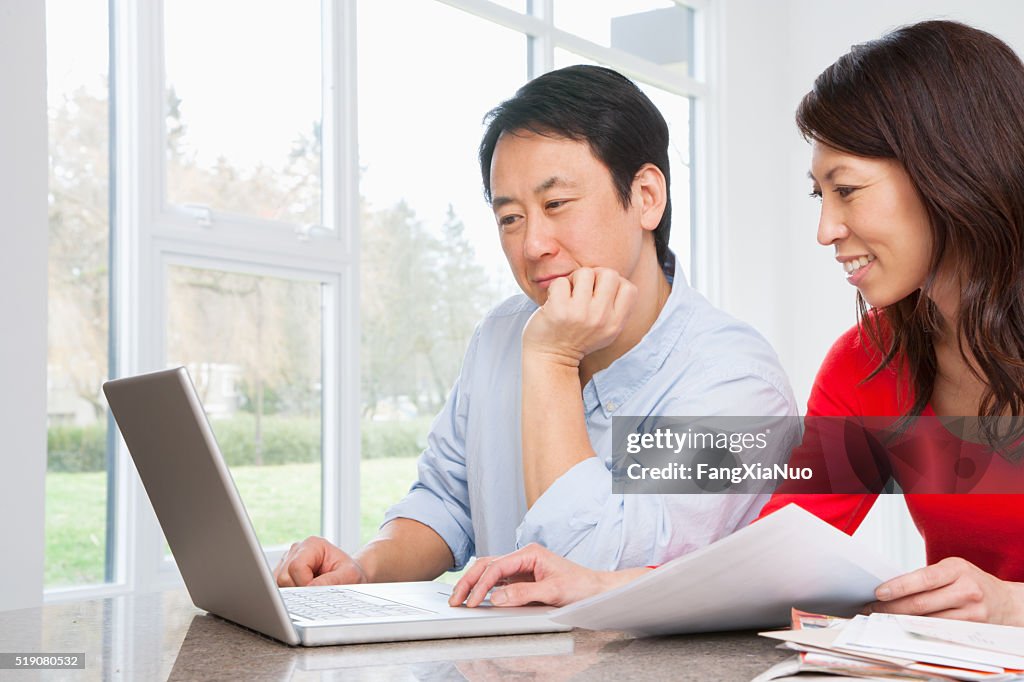 Couple using laptop to do finances