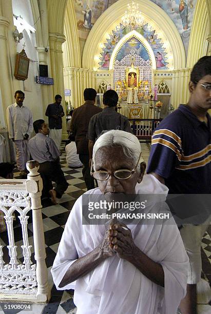 An old Indian devotee leaves after offering prayer during a special prayer meeting for tsunami victims at the Basilica Shrine in Velankanni 365 kms...