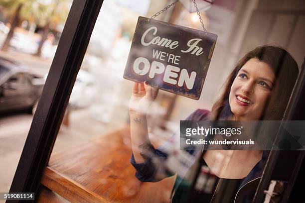 business woman owner turning opening sign on door coffee shop - butiksinvigning bildbanksfoton och bilder