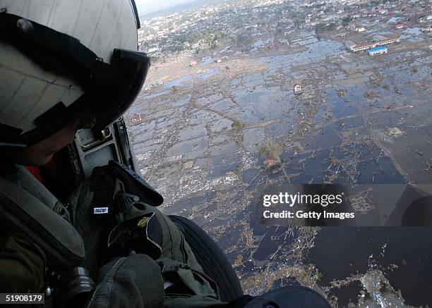 In this handout photo from the U.S. Navy, Aviation Anti-submarine Warfare Operator 2nd Class Timothy Sullivan views the devastation over Banda Aceh...