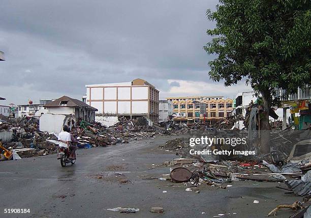 In this handout photo from the Department of Defense, wreckage and debris line the streets on January 1, 2005 following a massive tsunami that struck...