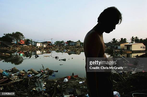 Thai man searches through debris looking for his possessions, January 2, 2005 in Takua Pa, Thailand. Thai residents in affected areas have begun to...