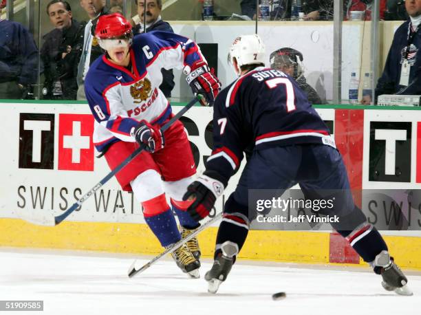 Forward Alexander Ovechkin of Russia shoots the puck through the legs of defenseman Ryan Suter of Team USA to score an empty net goal during the...