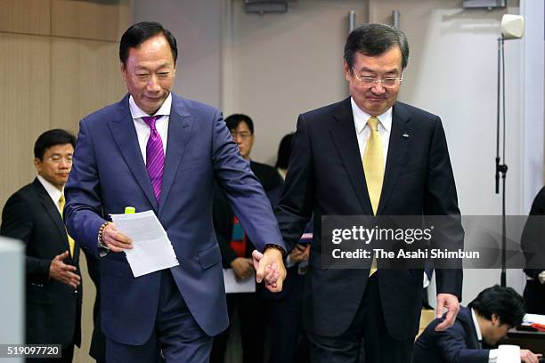 Hon Hai Precision Industry chairman Terry Gou and Sharp President Kozo Takahashi hold their hands enter to the room for the signing ceremony on April...