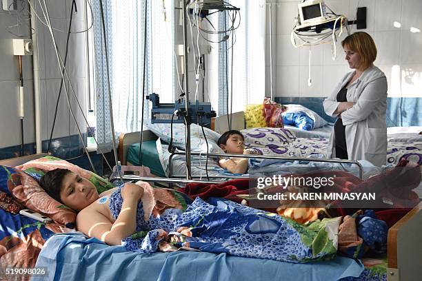 Boys, who were wounded in shelling during clashes between Armenian and Azeri forces over the Nagorny Karabakh region, receive medical treatment at a...