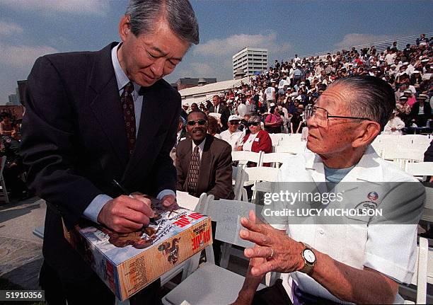 This 05 June 1999 file photo shows Congressman Robert Matsui as he signs the "GI Joe" game box of Japanese-American World War II soldier Kiyo Yamatz...