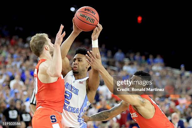 Joel Berry II of the North Carolina Tar Heels with the ball against Trevor Cooney and Michael Gbinije of the Syracuse Orange during the NCAA Men's...