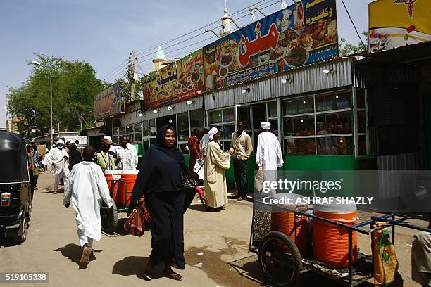 Sudanese woman walks at a food market in the city of Nyala, in south Darfur, on April 4, 2016. Sudanese President Omar al-Bashir is a tour of Darfur...