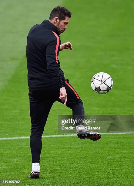 Diego Simeone head coach of Atletico Madrid juggles the ball during an Atletico Madrid training session ahead of their UEFA Champions League quarter...