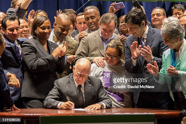 California Governor Jerry Brown signs landmark legislation SB 3 into law on April 4, 2016 in Los Angeles, California. The law makes California the...