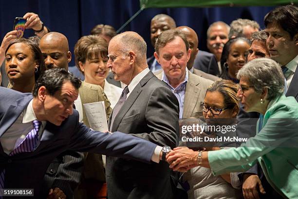 Dignitaries celebrate after California Governor Jerry Brown signed landmark legislation SB 3 into law on April 4, 2016 in Los Angeles, California....