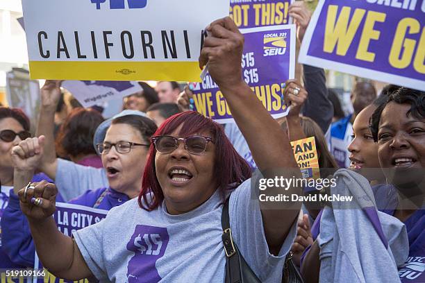 Service Employees International Union members celebrate after California Governor Jerry Brown signed landmark legislation SB 3 into law on April 4,...