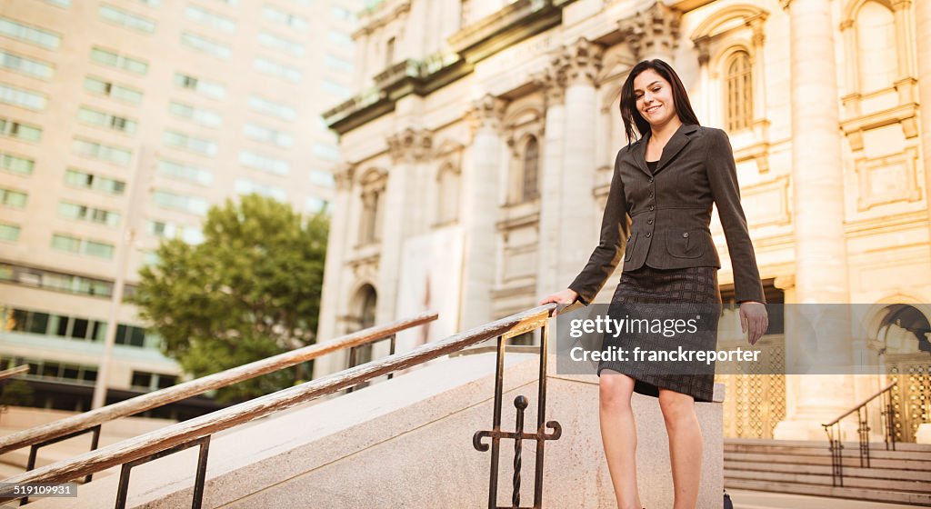 Successful business woman walking on the city