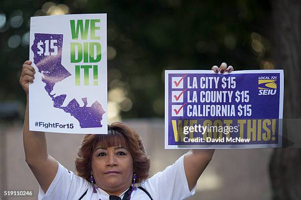 Service Employees International Union member celebrates after California Governor Jerry Brown signed landmark legislation SB 3 into law on April 4,...