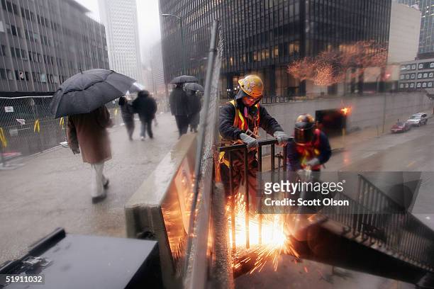 Workmen cut away a staircase outside the former Chicago Sun-Times newspaper building January 3, 2004 in Chicago, Illinois. The building, in downtown...