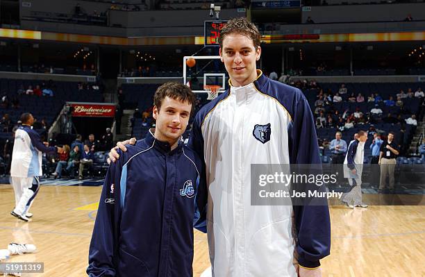 Pau Gasol of the Memphis Grizzlies and Raul Lopez of the Utah Jazz have a Spanish Olympic team reunion before a game at FedexForum on January 3, 2005...