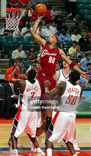 Drew Gooden of the Cleveland Cavaliers gets up for a dunk against Gerald Wallace and Emeka Okafor of the Charlotte Bobcats on January 3, 2005 at the...