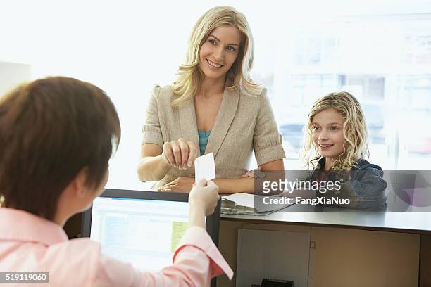 mother and daughter in a medical office - debit cards credit cards accepted stock pictures, royalty-free photos & images