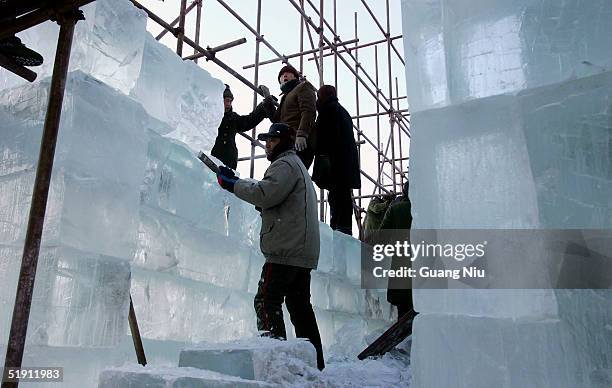 Labourers prepare the ice for the Ice and Snow Festival on January 4, 2005 in Harbin, China. The event, which is the first regional festival themed...