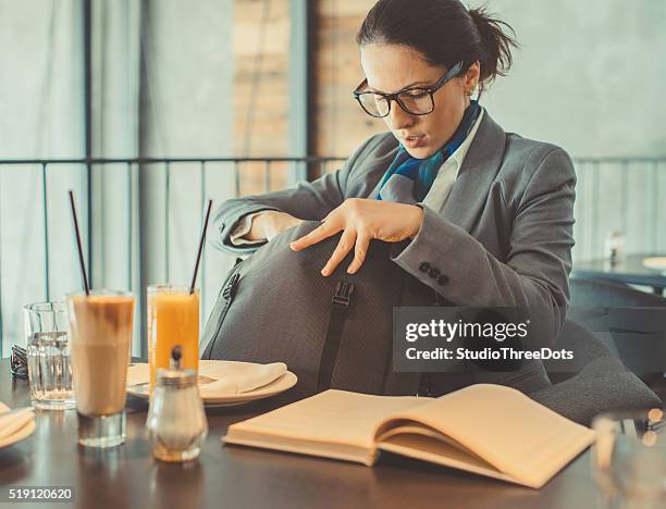 businesswoman checking her purse - forgot something stockfoto's en -beelden