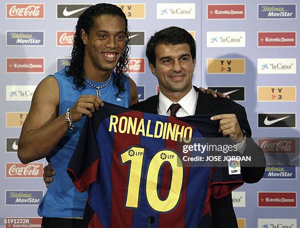 - This photo taken 21 July 2003 in Barcelona shows Brazilian player Ronaldinho with Paris PSG soccer club president Joan Laporta during Ronaldinho's...