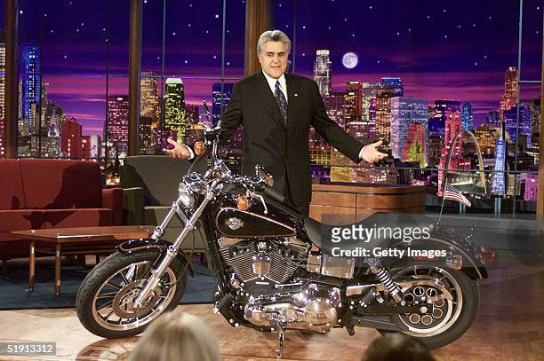 In this NBC Entertainment handout, "Tonight Show with Jay Leno" host Jay Leno stands next to a Harley-Davidson motorcycle January 3, 2005 in Burbank...