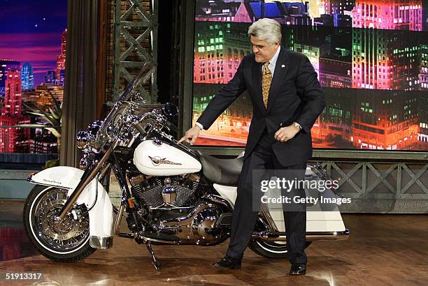 In this NBC Entertainment handout, "Tonight Show with Jay Leno" host Jay Leno stands next to a Harley-Davidson motorcycle January 3, 2005 in Burbank...