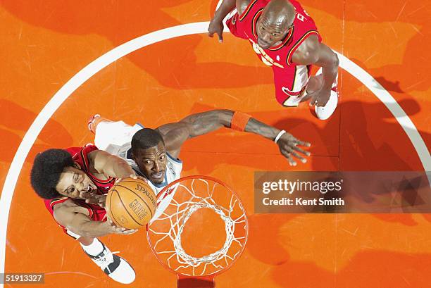 Gerald Wallace of the Charlotte Bobcats tries to defend against Josh Childress of the Atlanta Hawks during the game at Charlotte Coliseum on November...