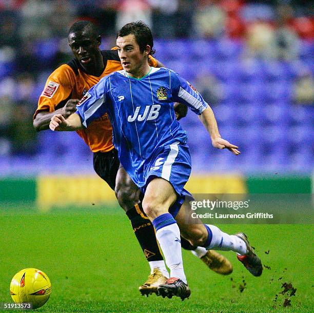 Leighton Baines of Wigan battles with Seyi Olofinjana of Wolves during the Coca-Cola Championship match between Wigan Athletic and Wolverhampton...